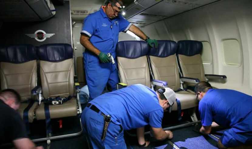 
Southwest Airlines technicians  install skinnier seats on a 737 at the carrier’s...