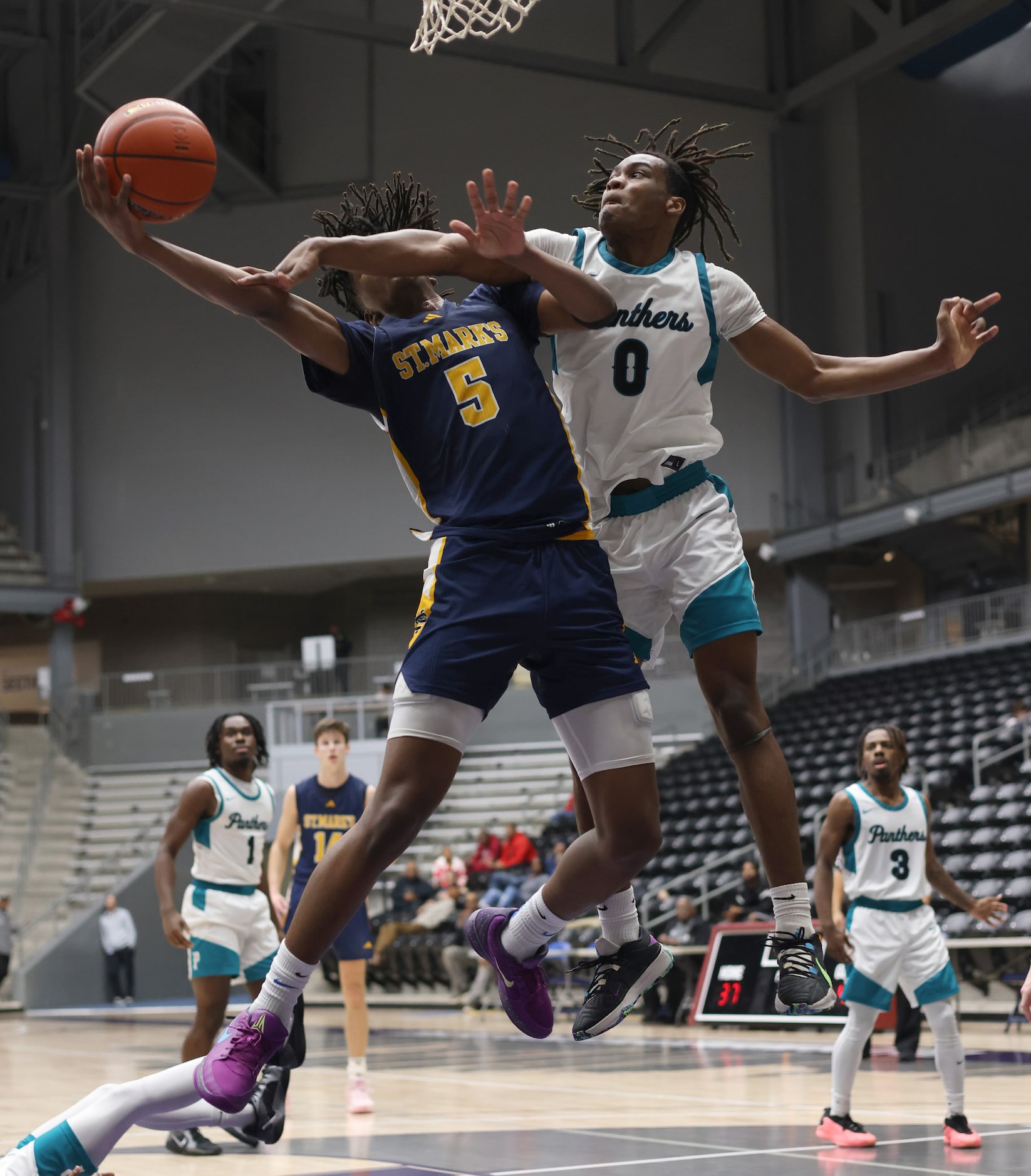 St. Mark's guard Dawson Battie (5), left, is fouled by Frisco Panther Creek forward Sentel...