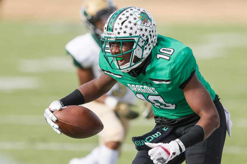 TXHSFB Southlake Carroll junior defensive back RJ Mickens (10) celebrates intercepting a...