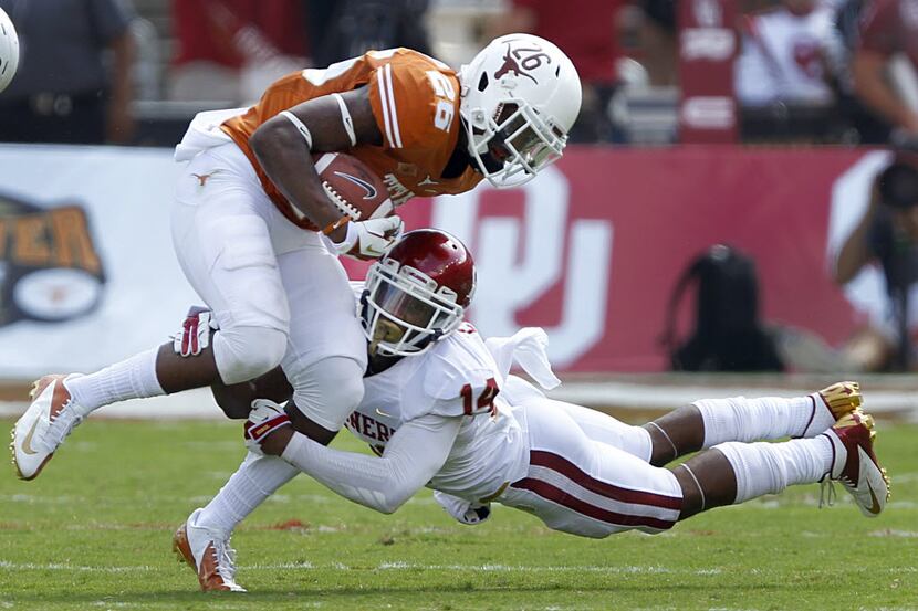 Oklahoma Sooners defensive back Aaron Colvin makes a sdivng tackle of Texas Longhorns safety...