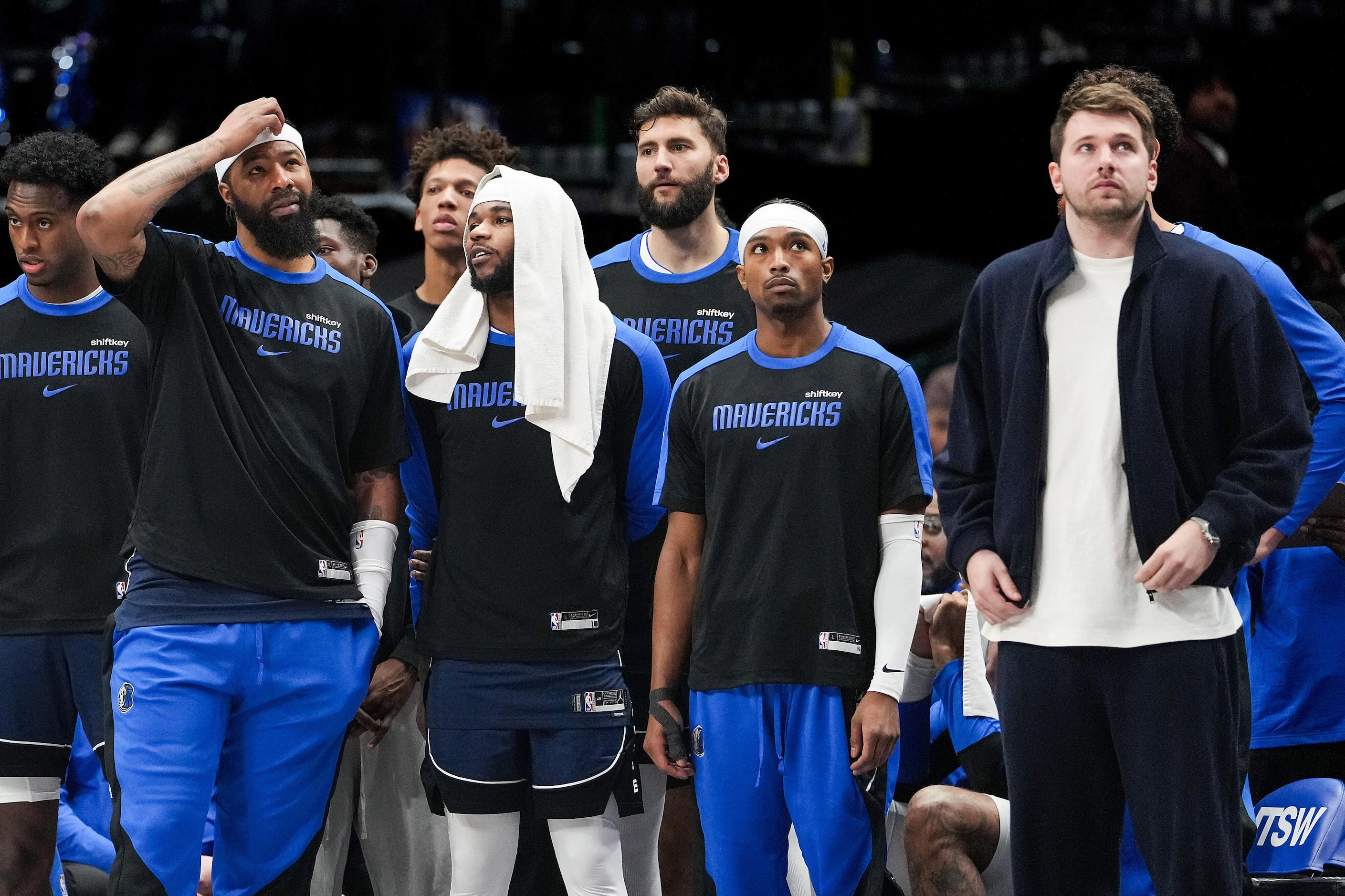 Dallas Mavericks guard Luka Doncic (right) watches from the bench during the second half of...