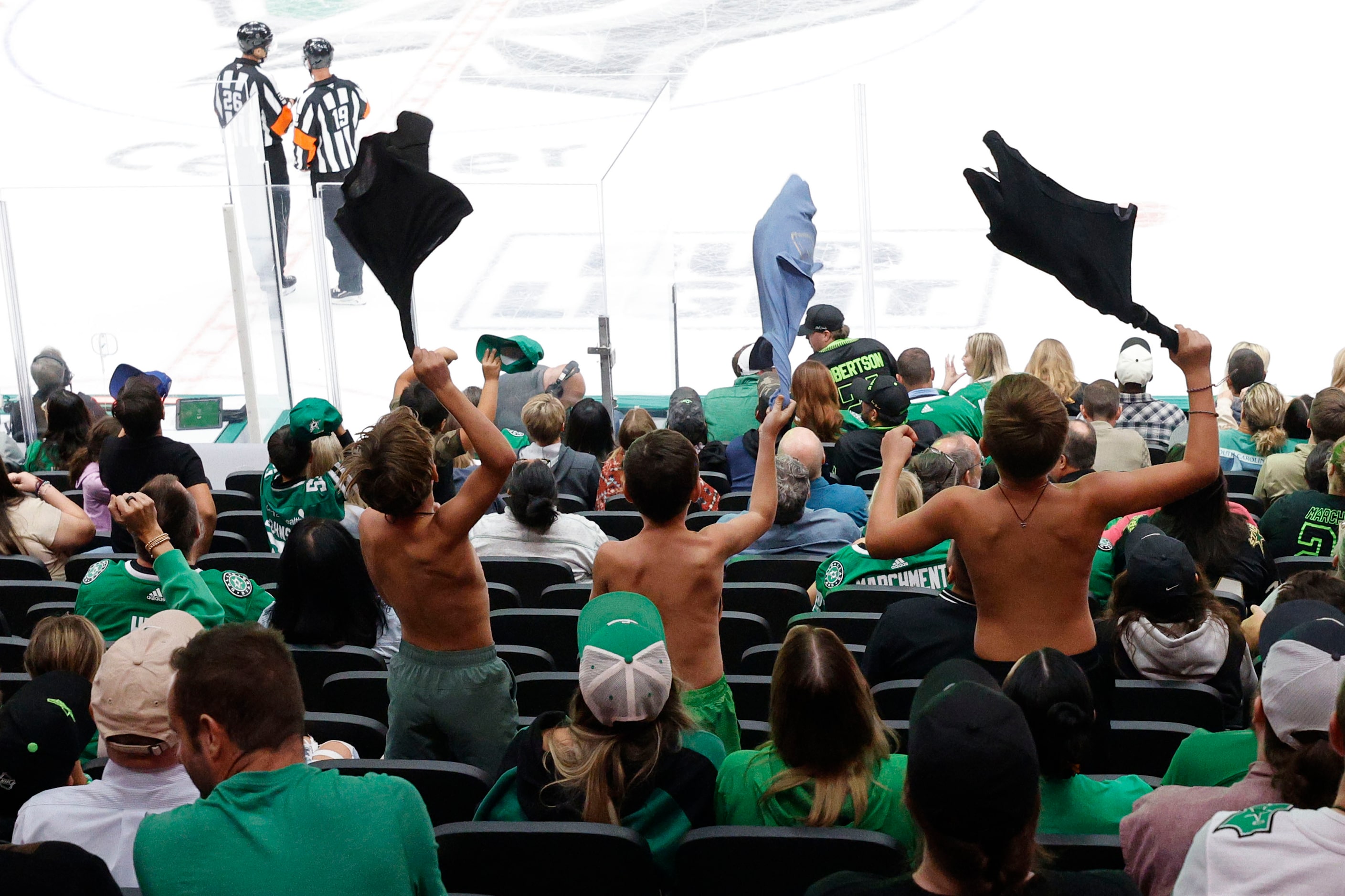 Fans cheer during an NHL preseason hockey game between the Dallas Stars and the Minnesota...