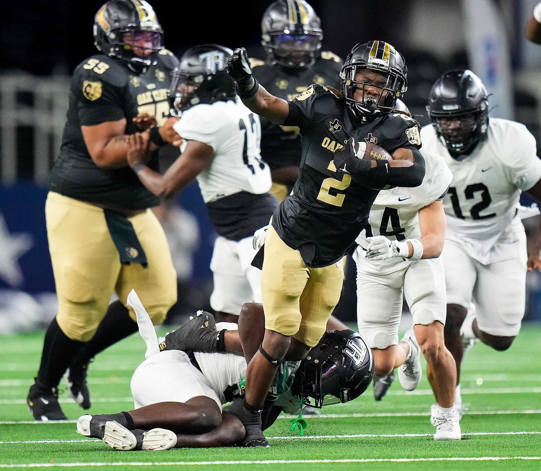 South Oak Cliff running back Mikail Trotter (2) is tripped up  by Richmond Randle defensive...