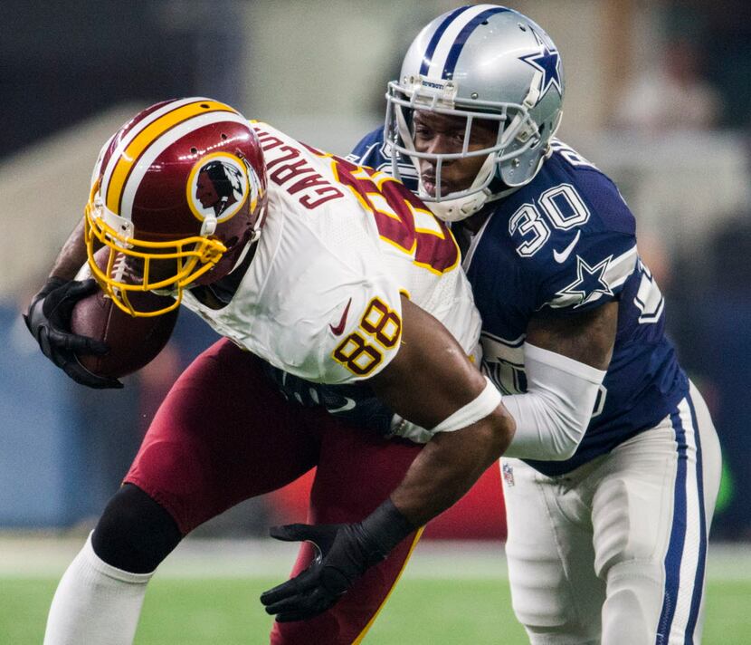 Dallas Cowboys cornerback Anthony Brown (30) tackles Washington Redskins wide receiver...