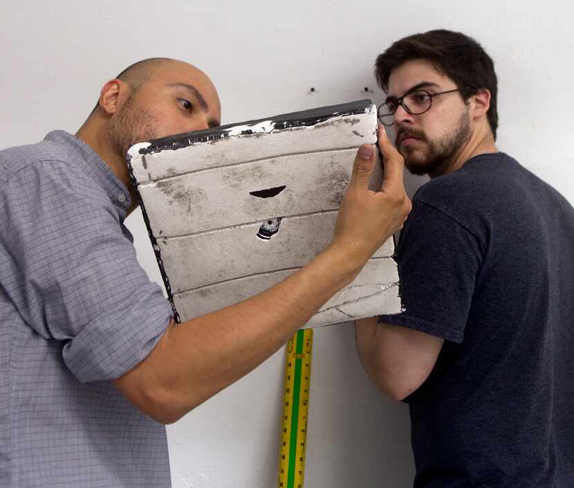 Artist Arthur Pena and gallery owner Kevin Rubén Jacobs installed a work by Pena titled...