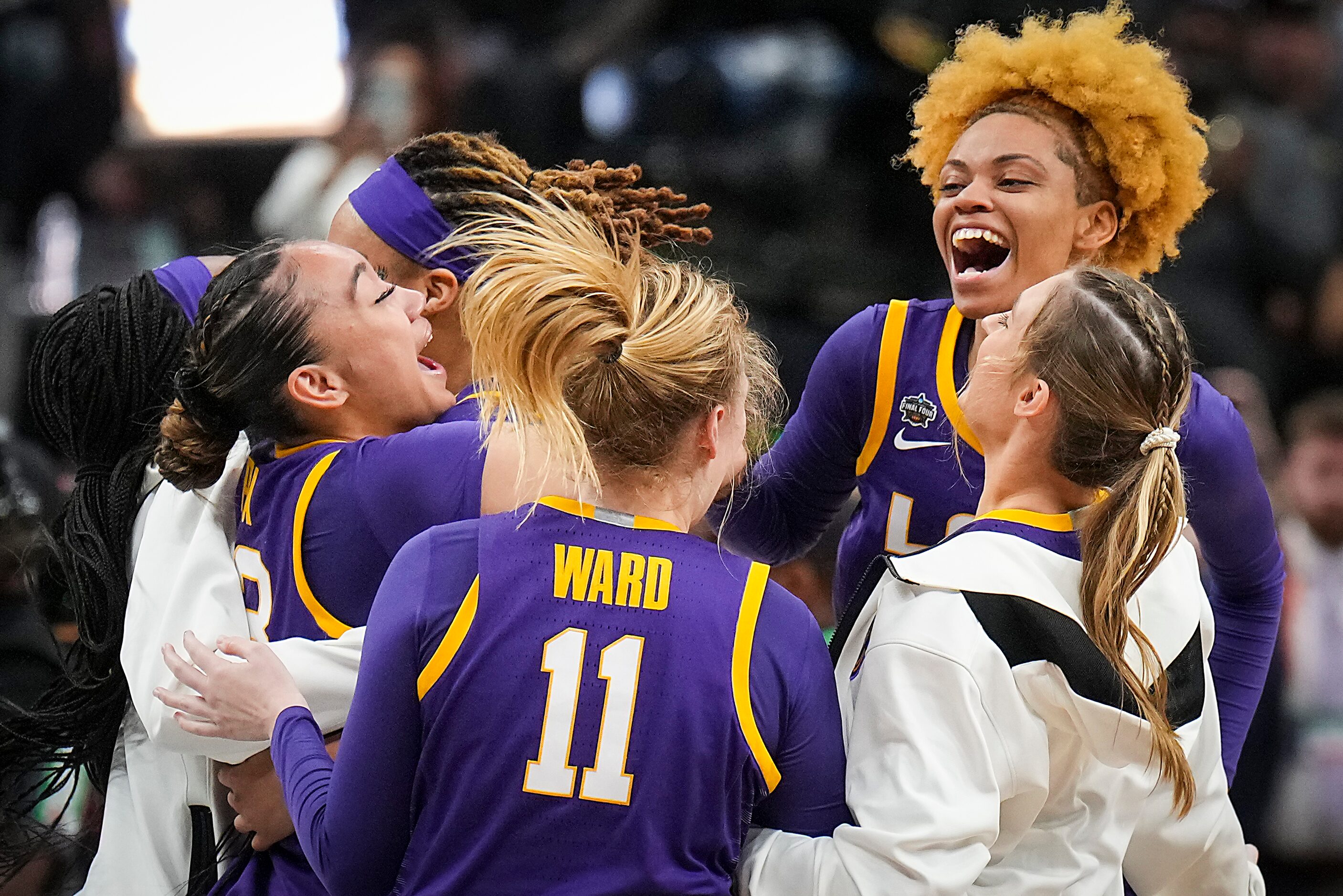 LSU players, including guard Last-Tear Poa (facing left), forward Emily Ward (11) and guard...