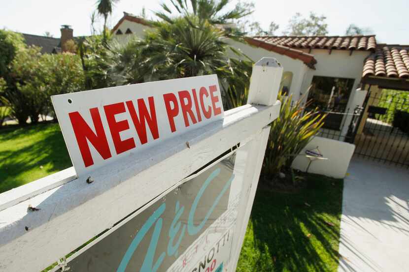 More home sellers are cutting prices as the market heads into the holidays.  (AP Photo/Reed...