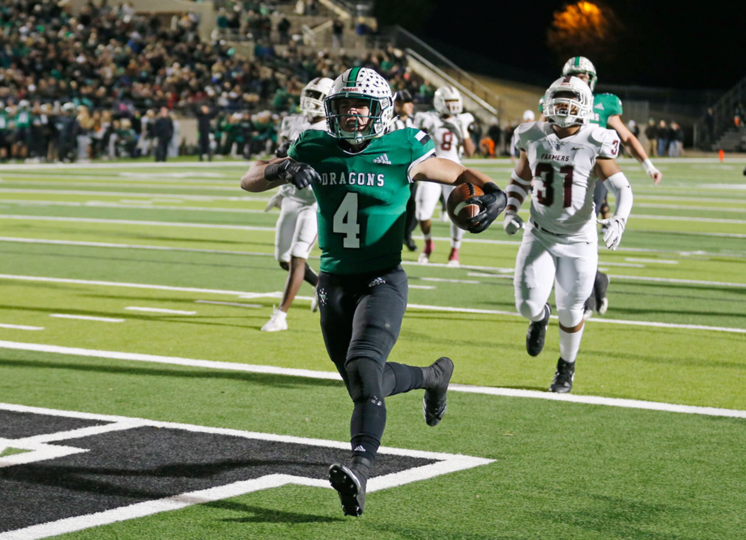 Southlake's Owen Allen (4) scores a touchdown as Lewisville's Carl Levy III (31) chases him,...
