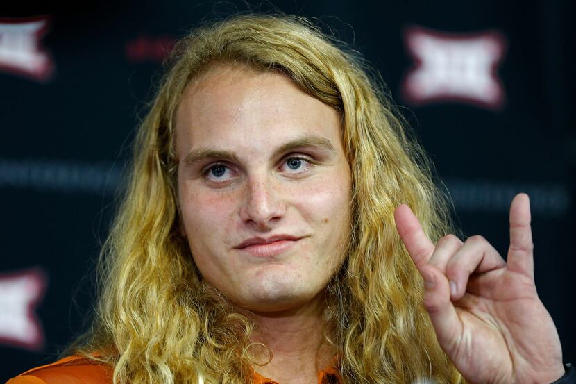 Texas defensive line Breckyn Hager poses for a photograph while he talks with the media in a...