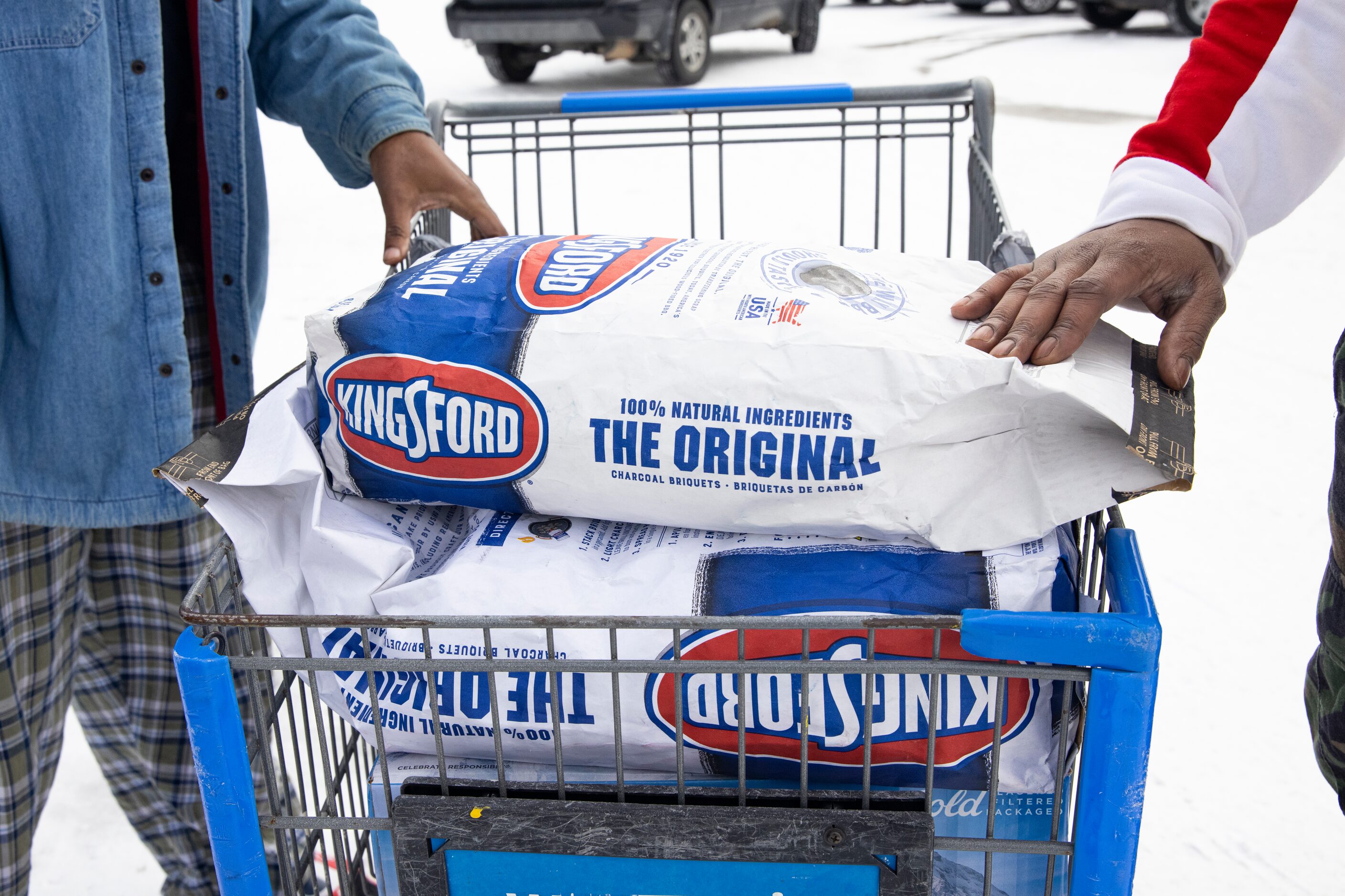 Reuben Brown (left) and Dekaetron McCalley wheel charcoal and a grill they bought at Walmart...