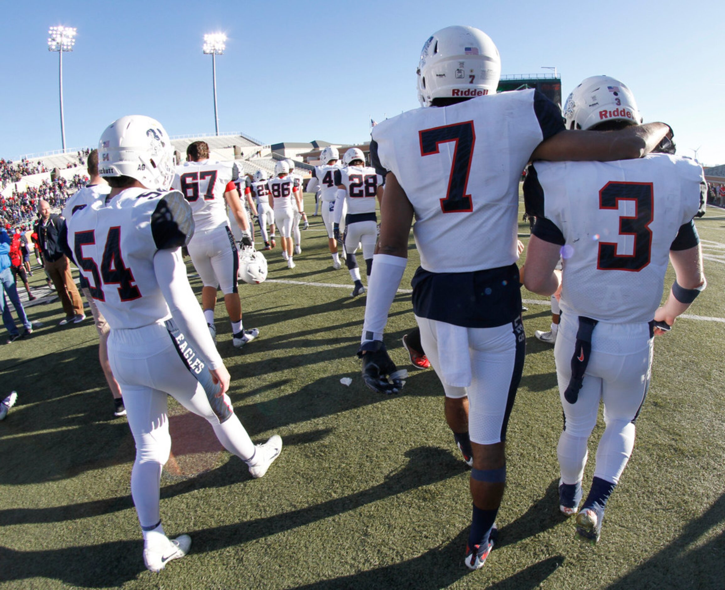 An exhausted but victorious group of Allen Eagles, including CJ Johnson (7) and Jack Fee (3)...