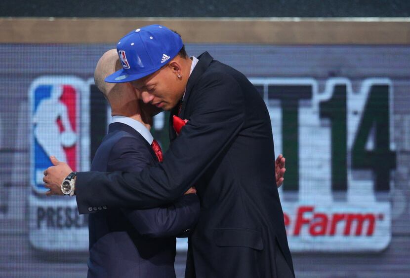 Jun 26, 2014; Brooklyn, NY, USA; Isaiah Austin (Baylor) hugs NBA commissioner Adam Silver...