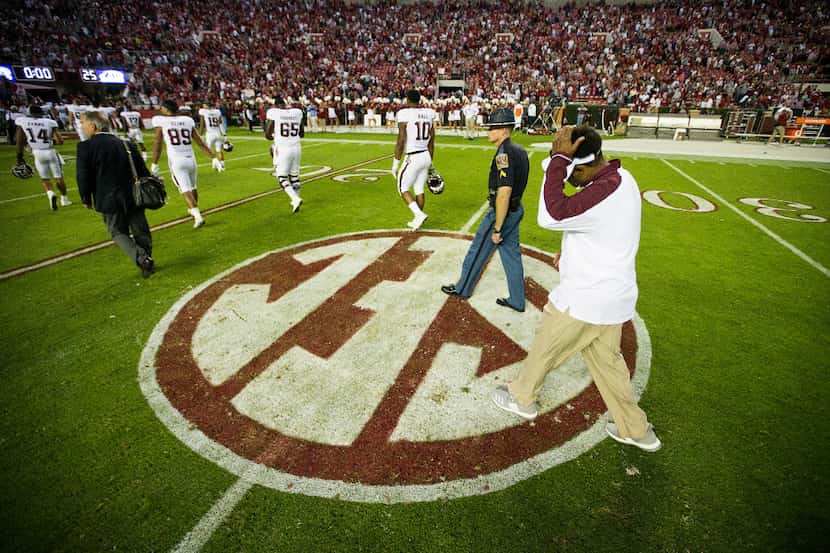 Texas A&M head coach Kevin Sumlin walks off the field after a loss to Alabama in an NCAA...