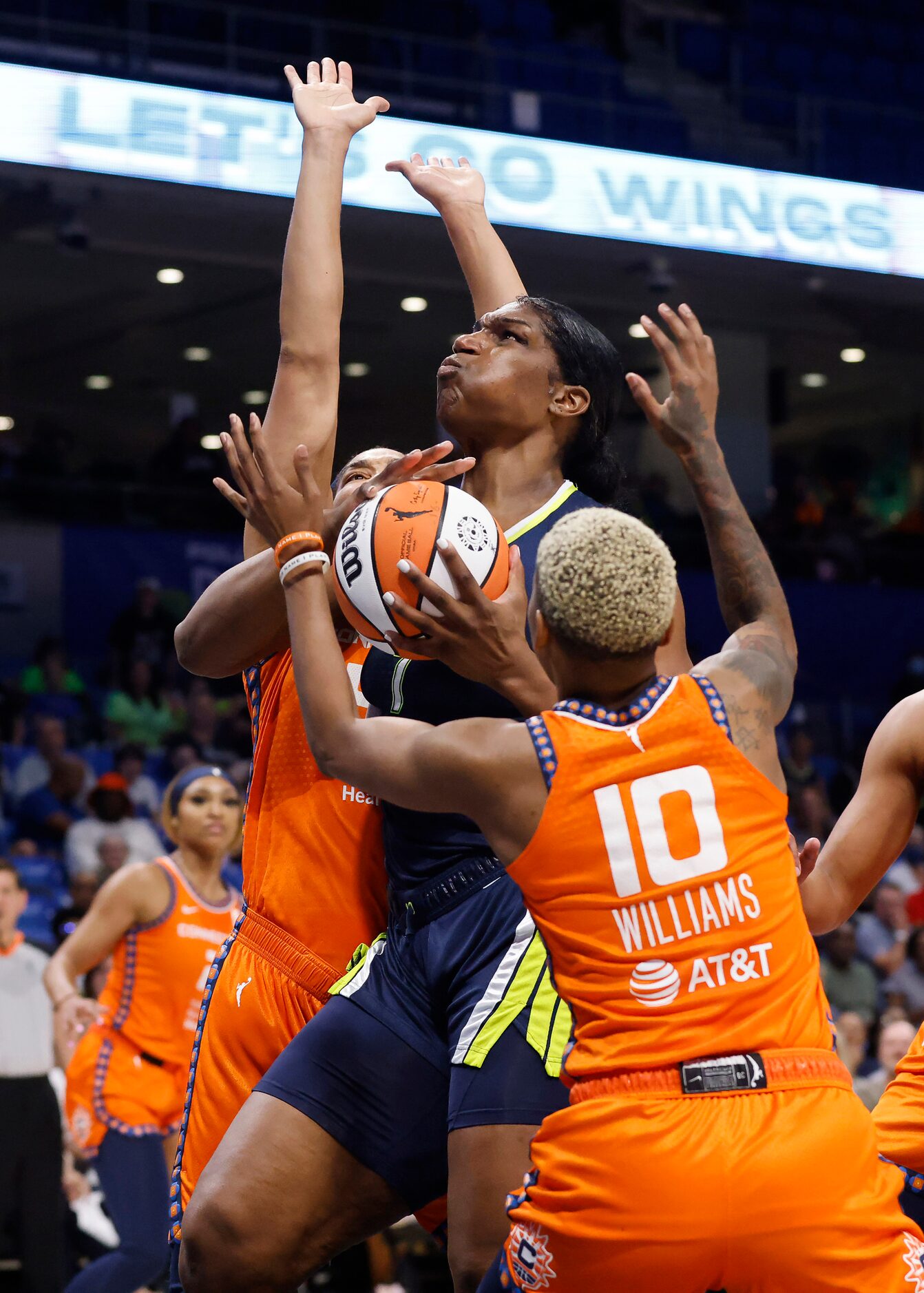 Dallas Wings center Teaira McCowan (7) goes up for a shot against Connecticut Sun guard...