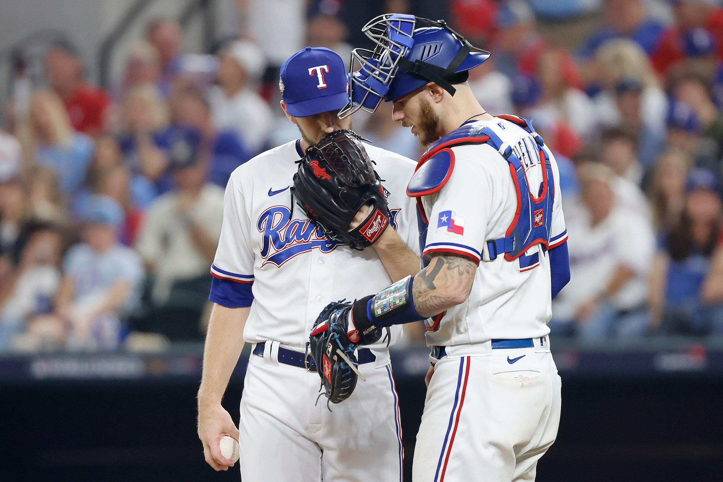 Texas Rangers relief pitcher Chris Stratton talks with catcher Jonah Heim during the eighth...