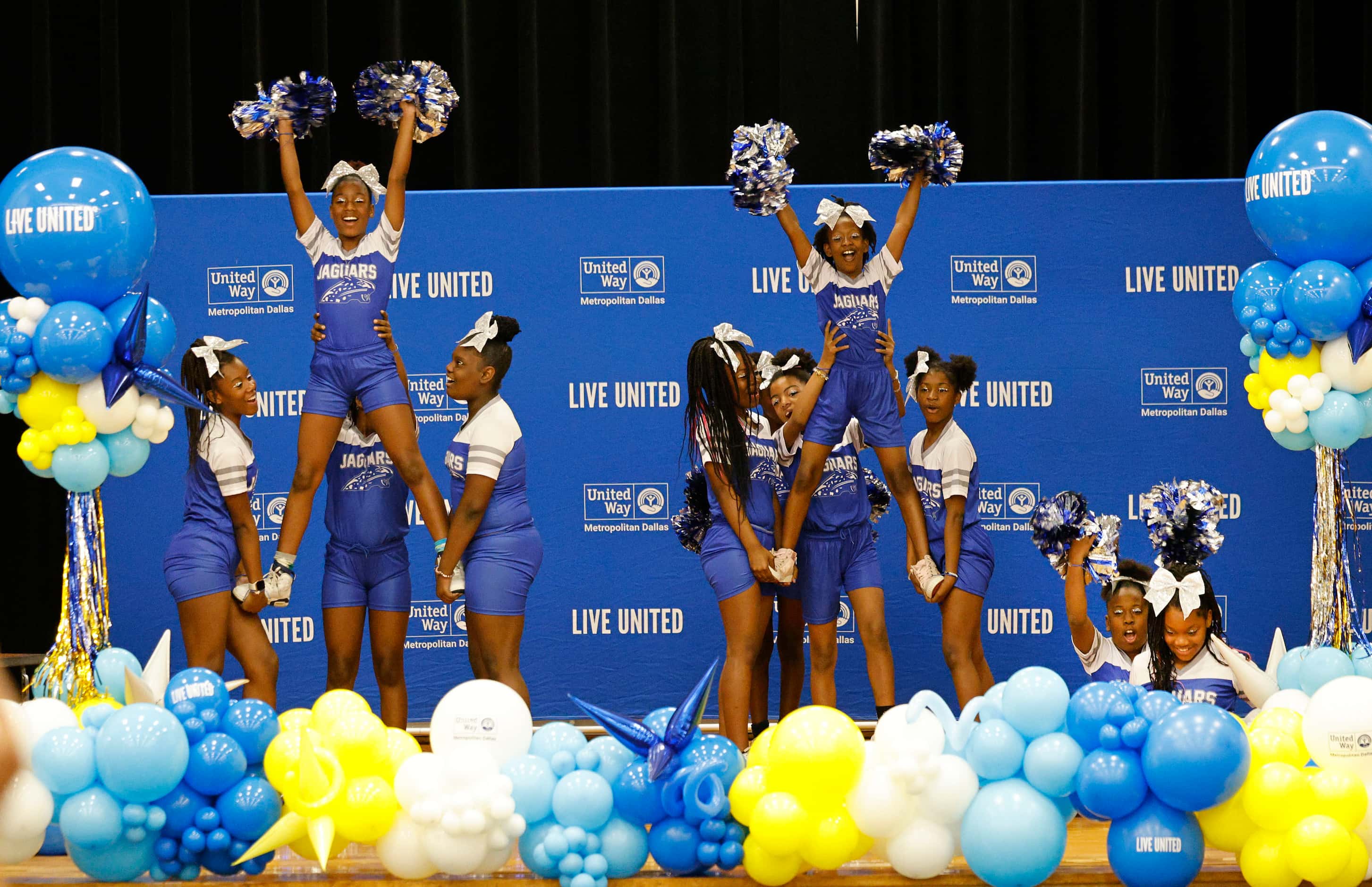 Students from the cheer and dance team perform during a reading day event hosted by United...