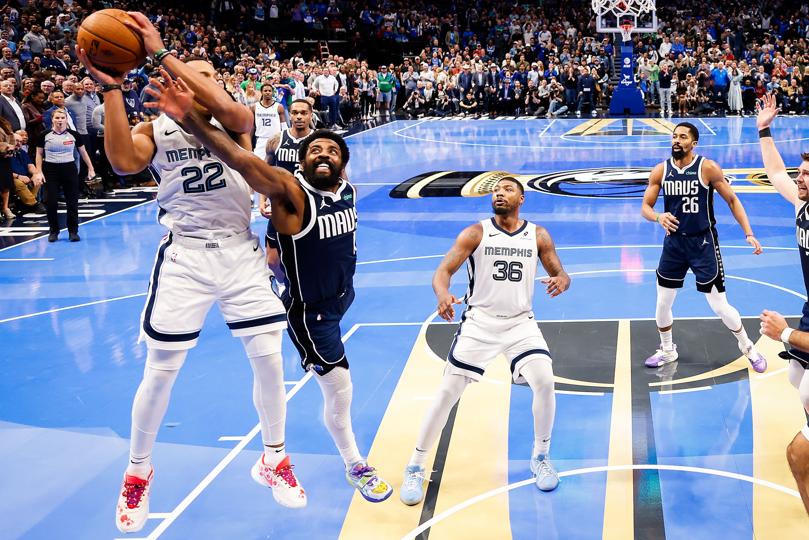 Dallas Mavericks guard Kyrie Irving (11) fights for a rebound against Memphis Grizzlies...