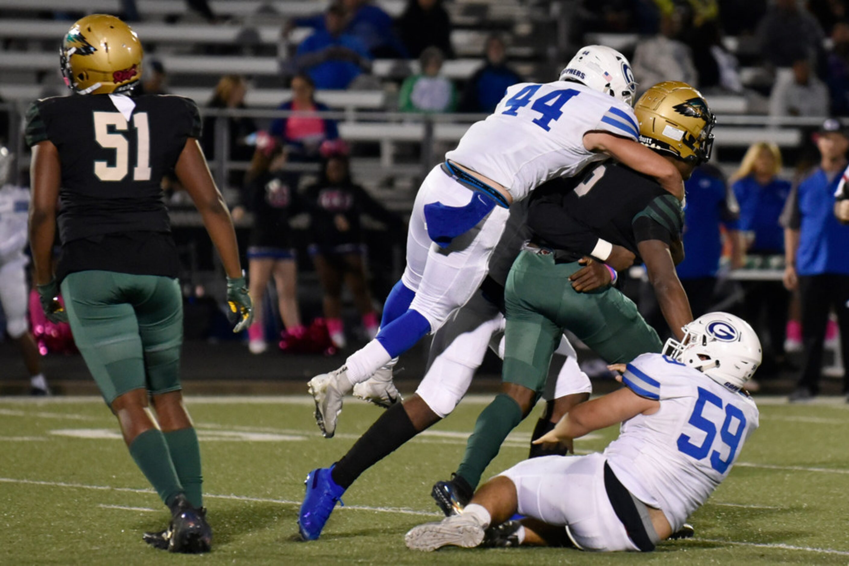 DeSoto High School lineman Yakiri Walker (51) gives up on a play as Grand Prairie High...