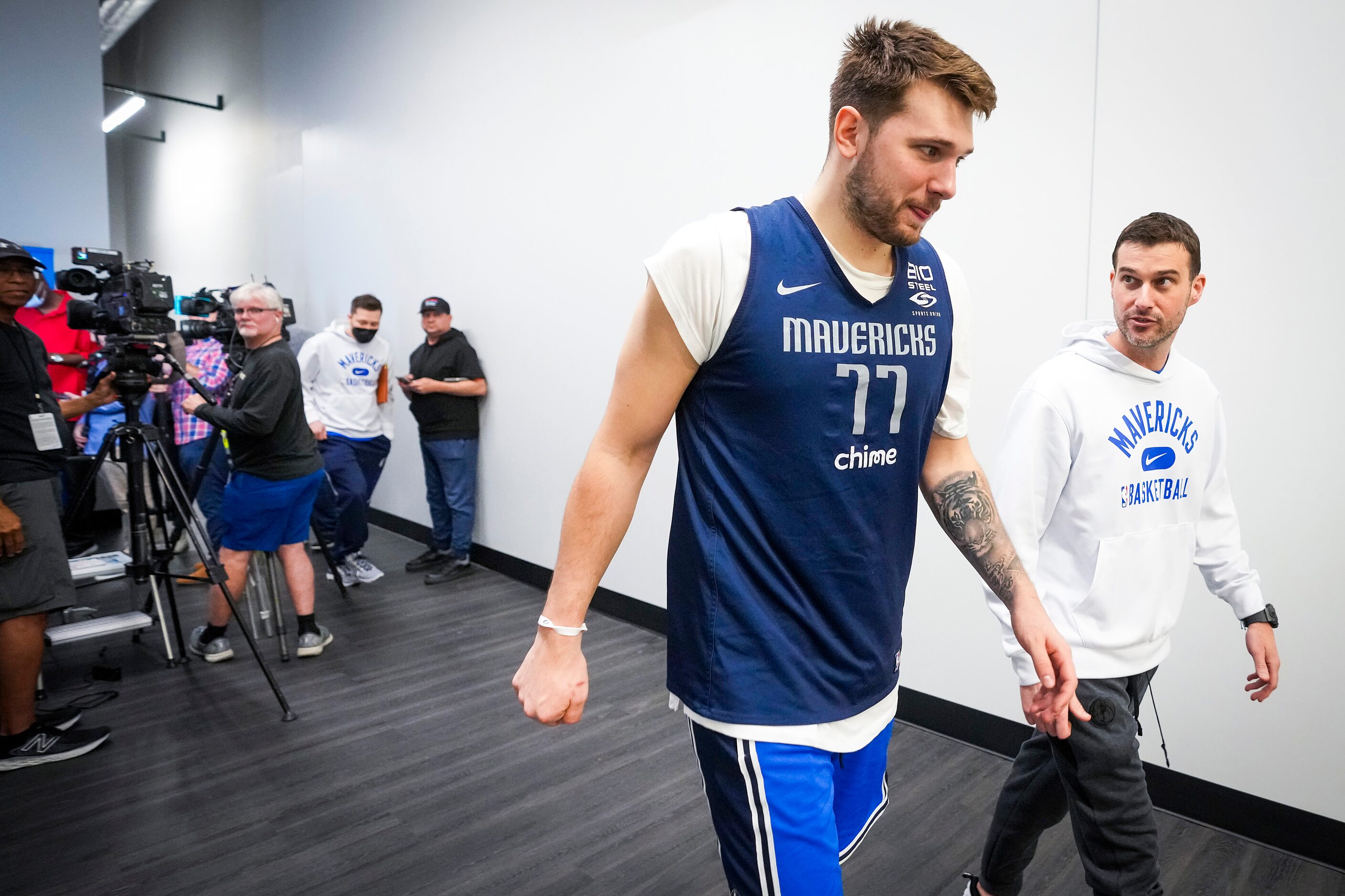 Dallas Mavericks guard Luka Doncic departs a media availability with Scott Tomlin, vice...