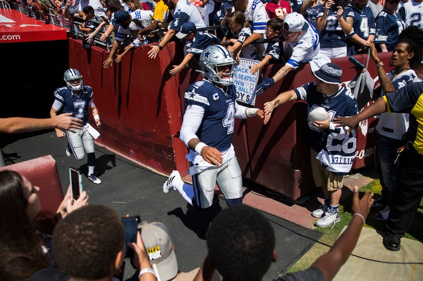 Dallas Cowboys quarterback Dak Prescott (4) enters the field to warm up before an NFL game...