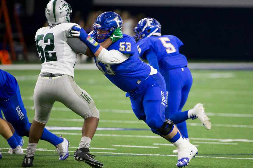 Frisco Raccoons offensive lineman Jack Anderson holds Reedy Lions Lawrence Lewis (52) during...