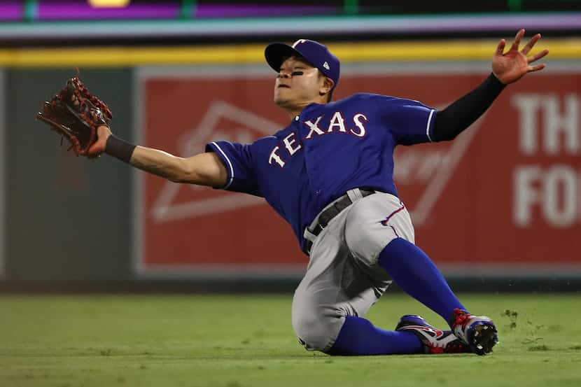 ANAHEIM, CA - SEPTEMBER 10: Shin-Soo Choo #17 of the Texas Rangers makes a sliding catch on...