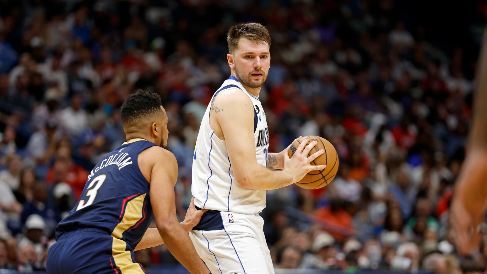 Dallas Mavericks guard Luka Doncic (77) is defended by New Orleans Pelicans guard CJ...