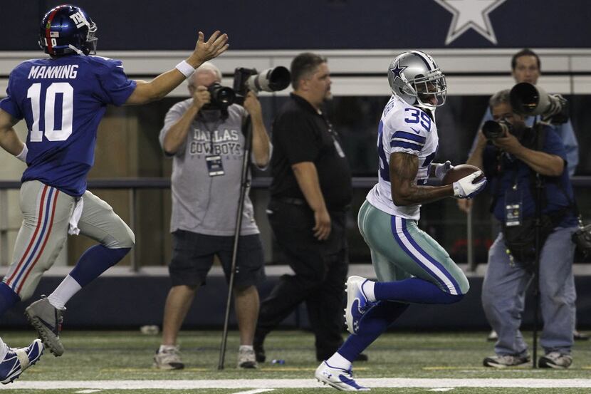 Dallas Cowboys cornerback Brandon Carr (39) returns an interception for a touchdown past New...