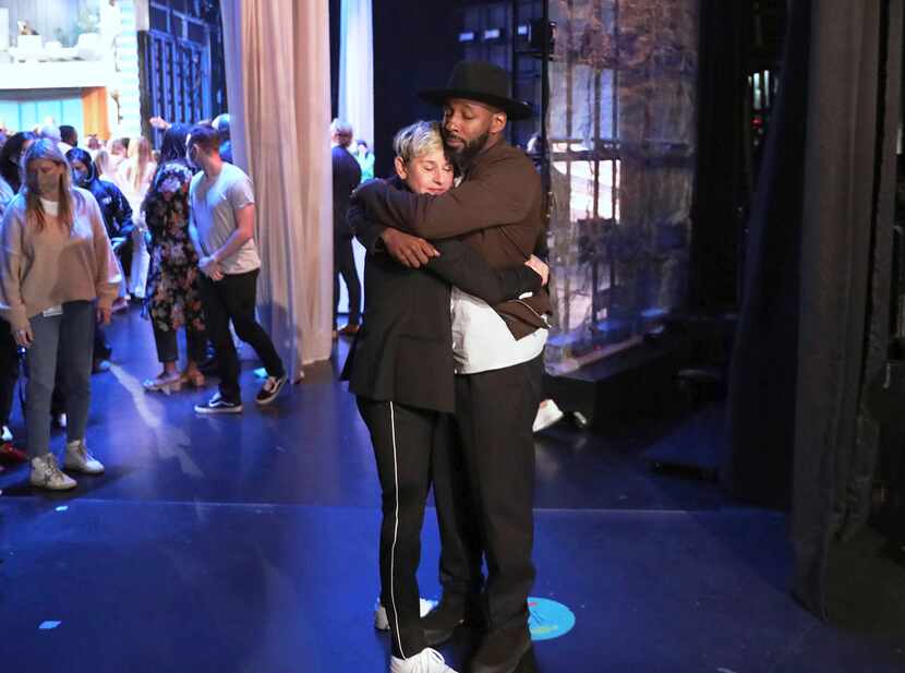 FILE - In this photo released by Warner Bros., talk show host Ellen DeGeneres embraces...