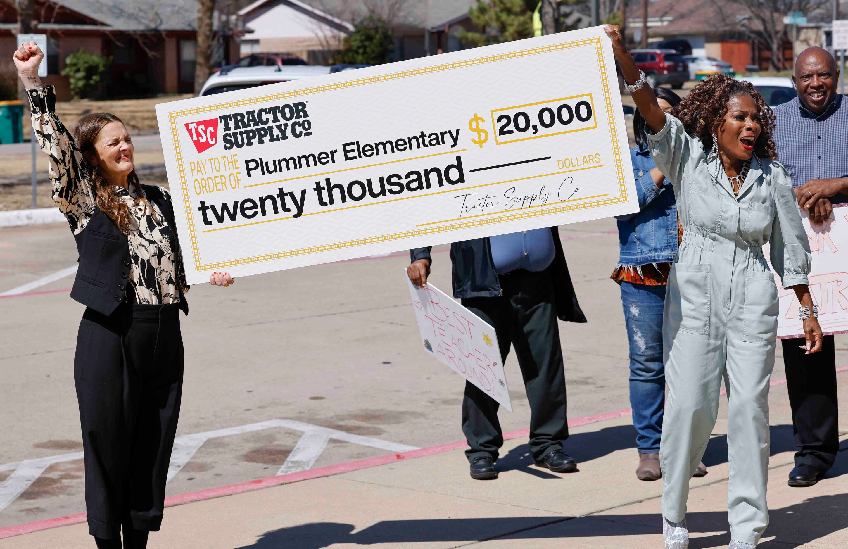 Patricia Byrd, right, reacts while receiving a check from Drew Barrymore during the...