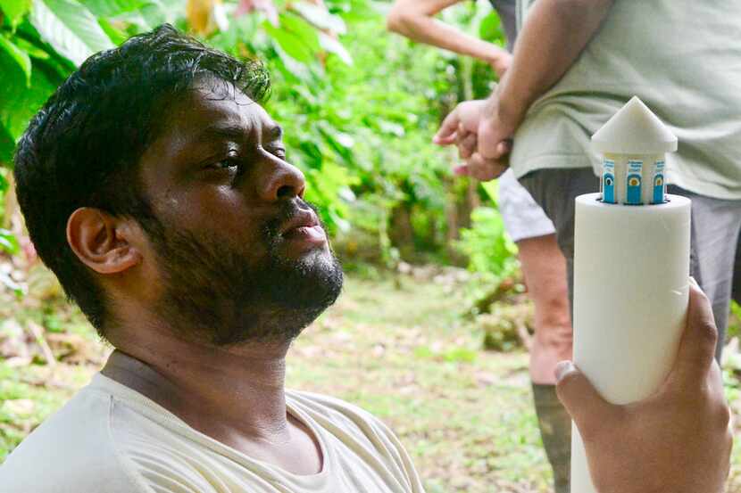 During a field test in Costa Rica, Vikram Dhamu examines a probe containing six soil health...