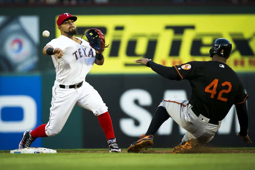 Texas Rangers second baseman Rougned Odor makes the relay on a double play over Baltimore...