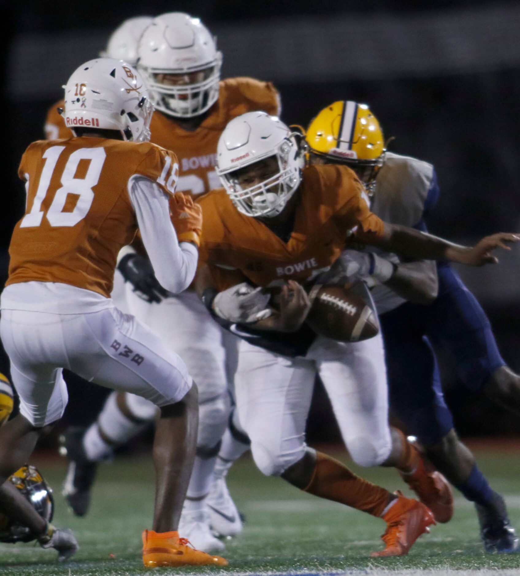 Arlington Bowie quarterback Drevvon Ponder (14) fumbles after being hit by Arlington Lamar...