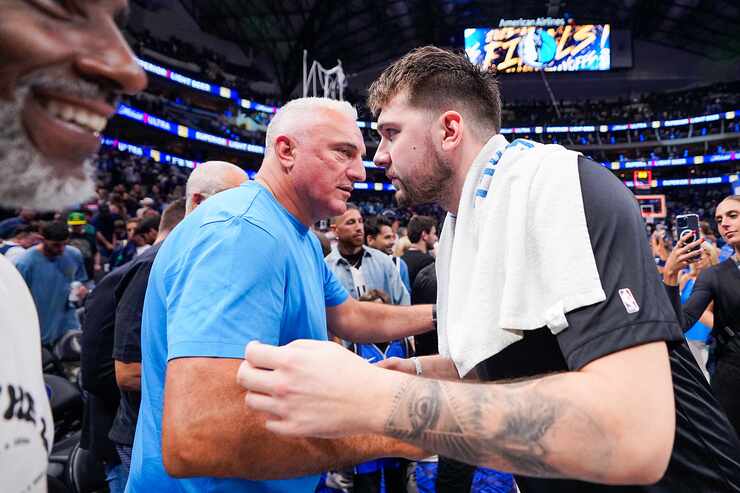 Dallas Mavericks guard Luka Doncic hugs his father Sasa after a victory over the Boston...