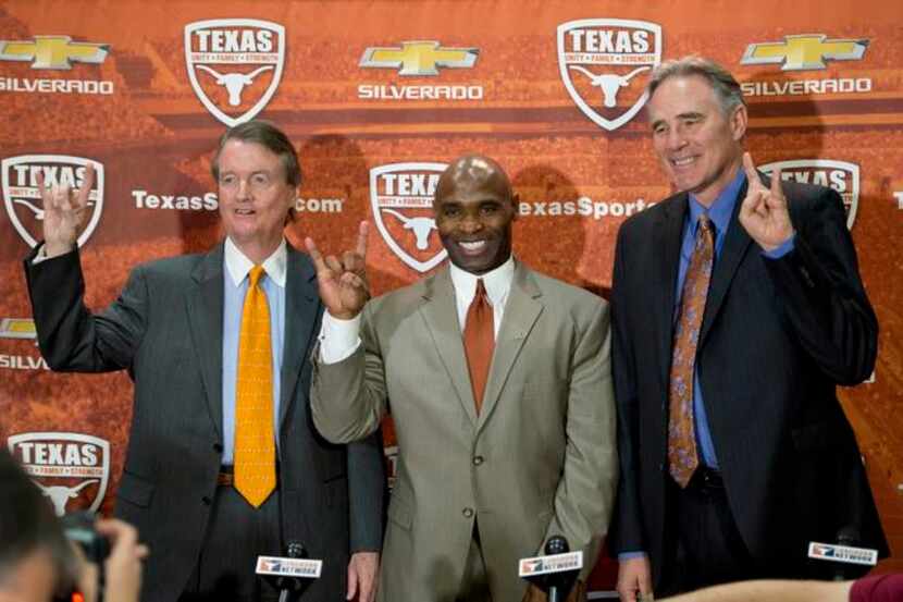 Charlie Strong, center, poses with Texas president Bill Powers, left, and athletic director...