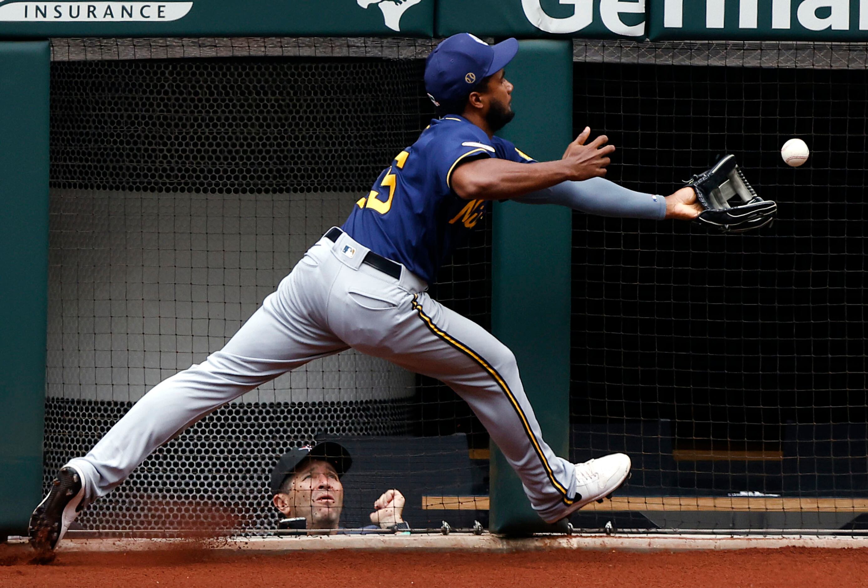 Milwaukee Brewers third baseman Pablo Reyes bobbles a Texas Rangers fly ball in the sixth...
