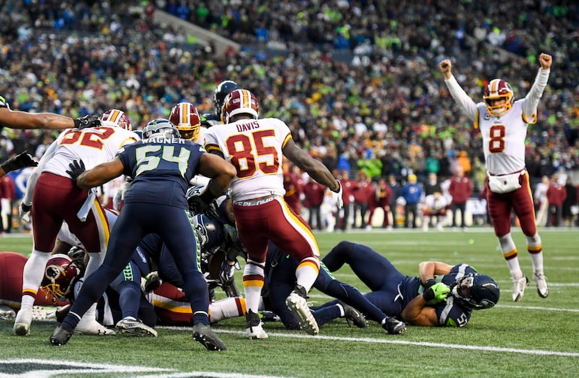 Redskins quarterback Kirk Cousins (8) celebrates as running back Rob Kelley (20) scores the...