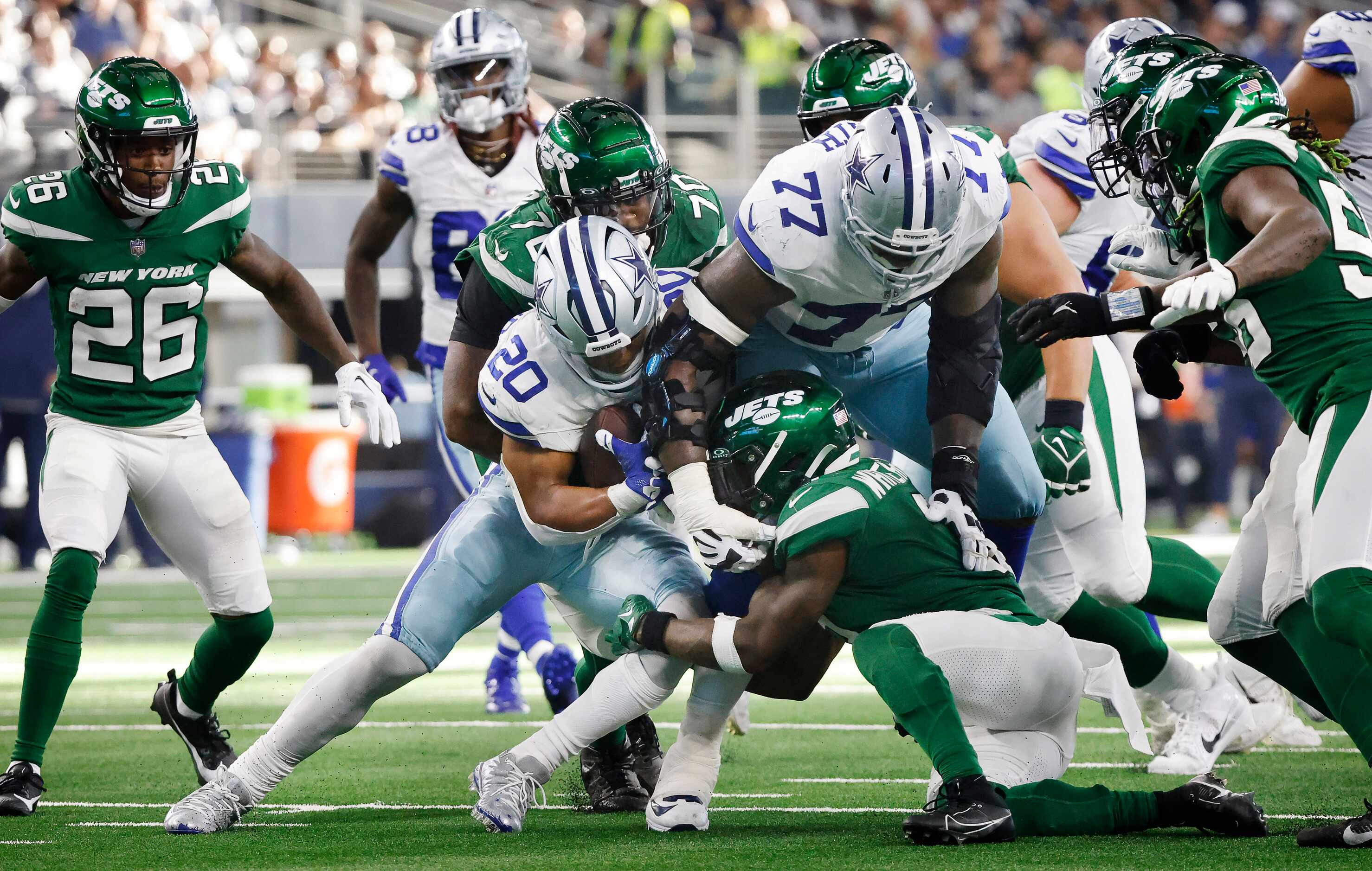 Dallas Cowboys running back Tony Pollard (20) is stopped by the New York Jets defense during...