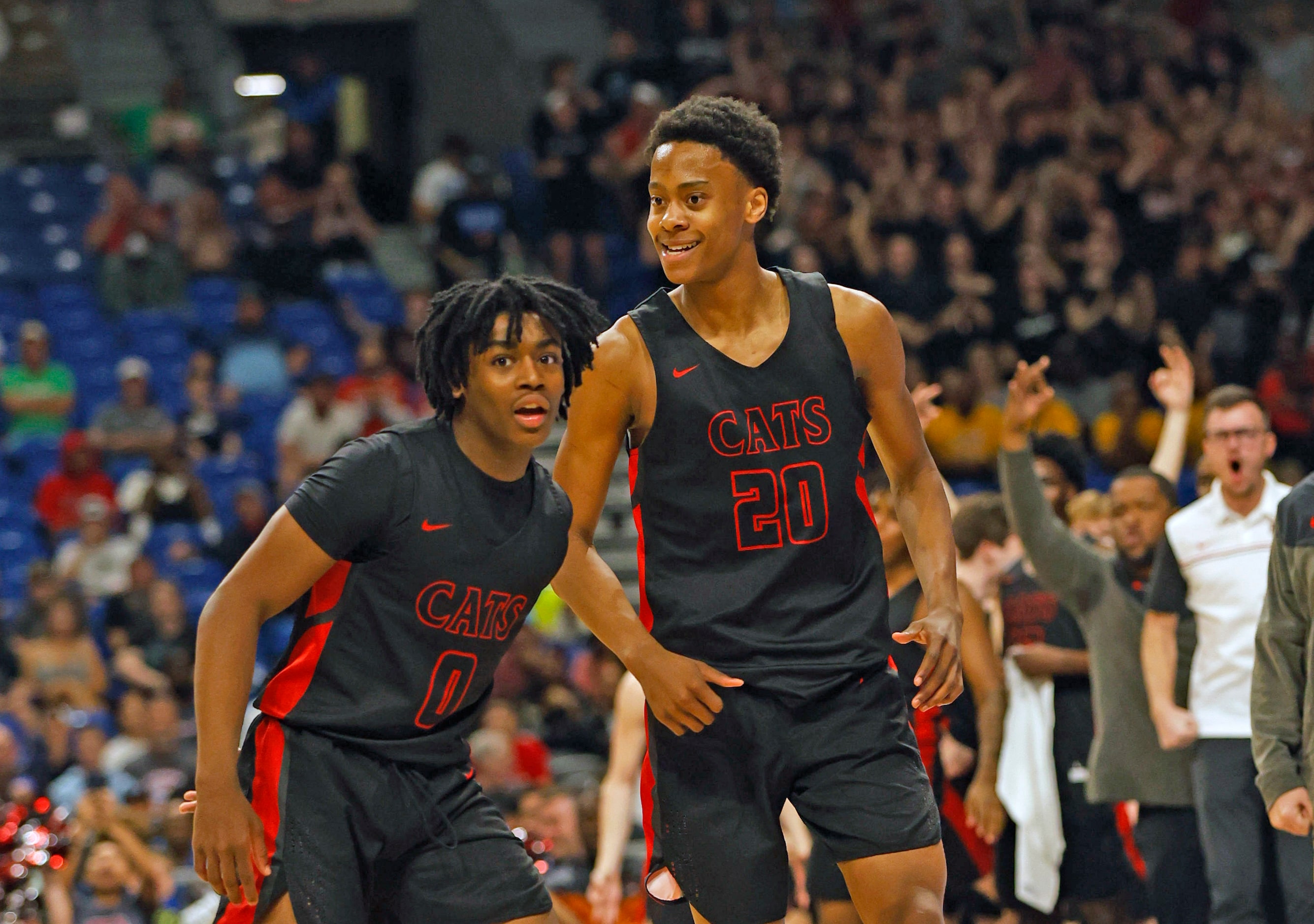 Lake Highlands Tre Johnson (20) smiles next to Jaylen Washington (0) after hitting a three....