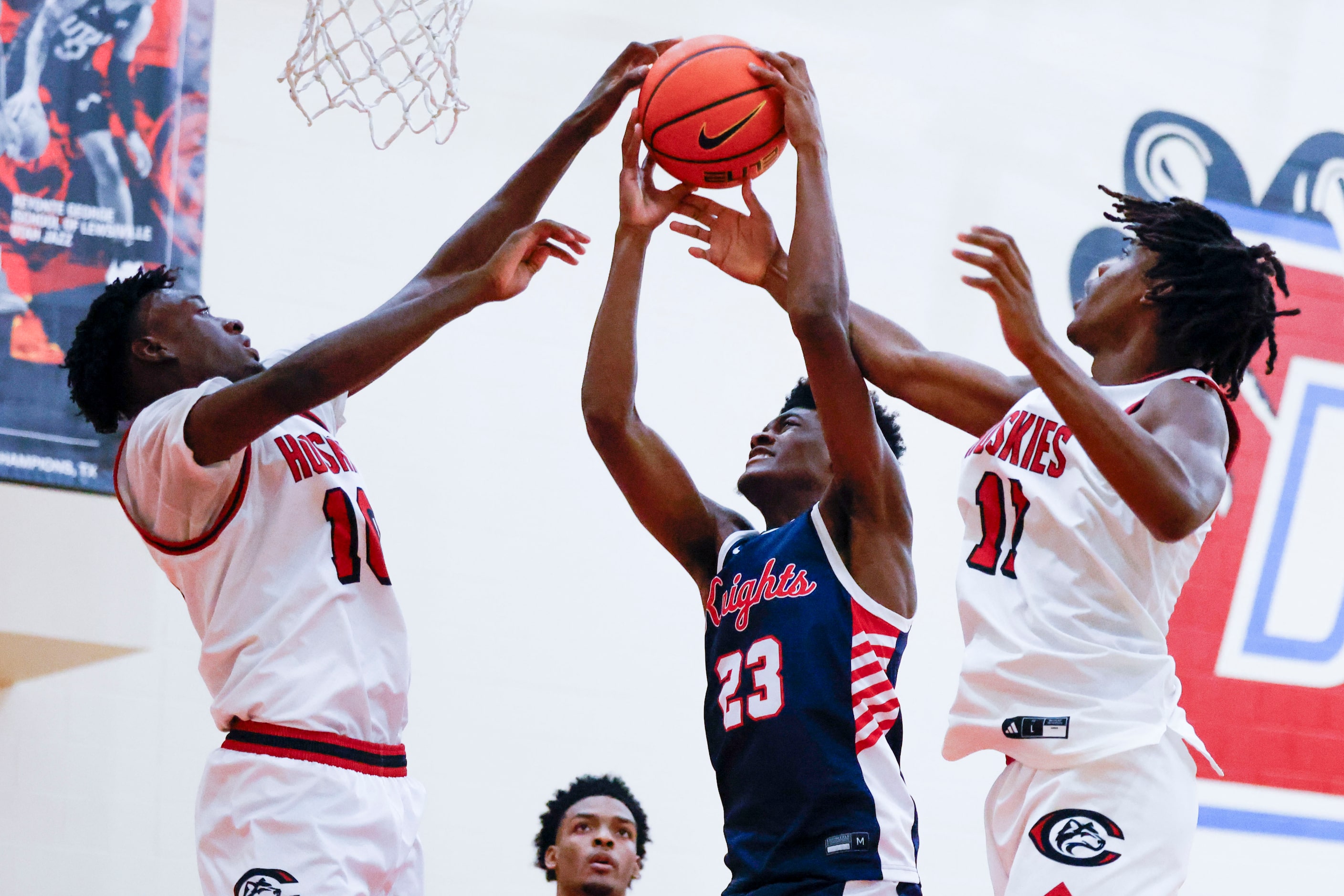 Kimball High’s Jaylin Hancock (23) gets blocked by Centennial High’s Josh Agloo (right)...