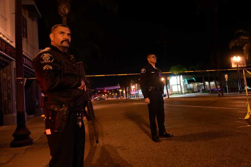 Two police officers stood guard near a scene where a shooting took place in Monterey Park,...