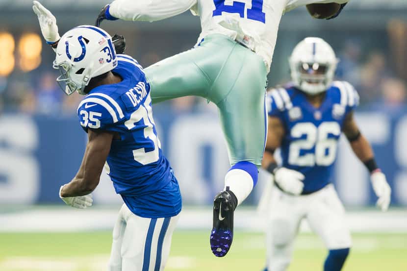 Dallas Cowboys running back Ezekiel Elliott (21) jumps over Indianapolis Colts cornerback...