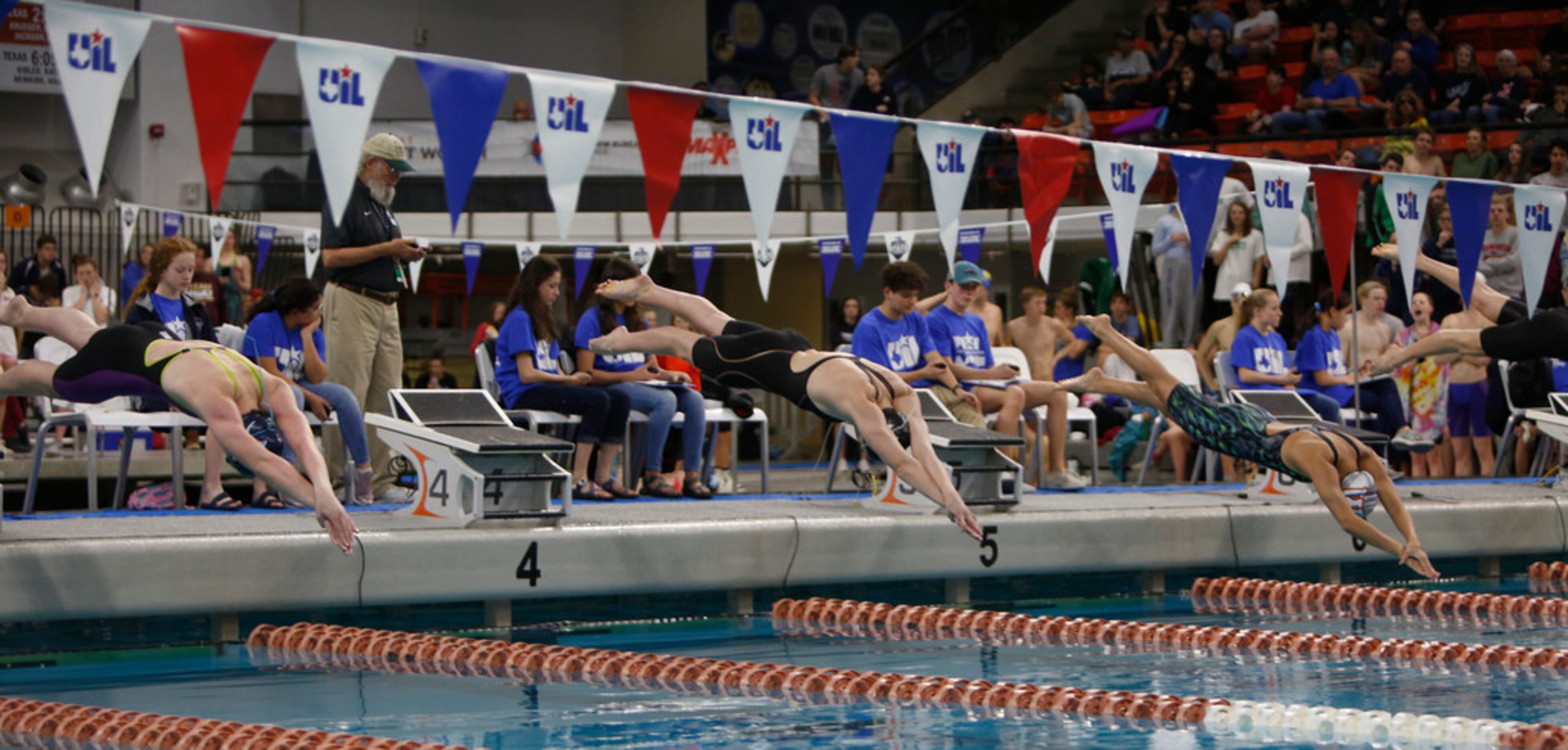 Southlake Carroll's Kit Kat Zenick (center) dives at the start of the Girls 50 Yard...