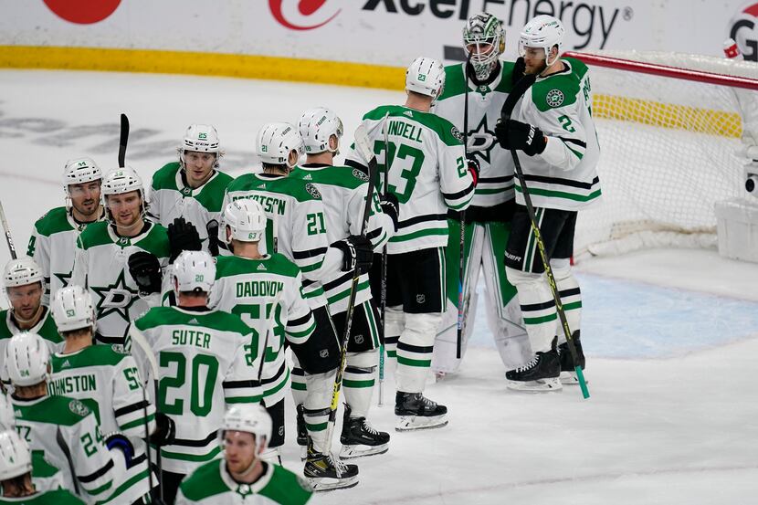 Dallas Stars goaltender Jake Oettinger, second from right, celebrates with teammates...