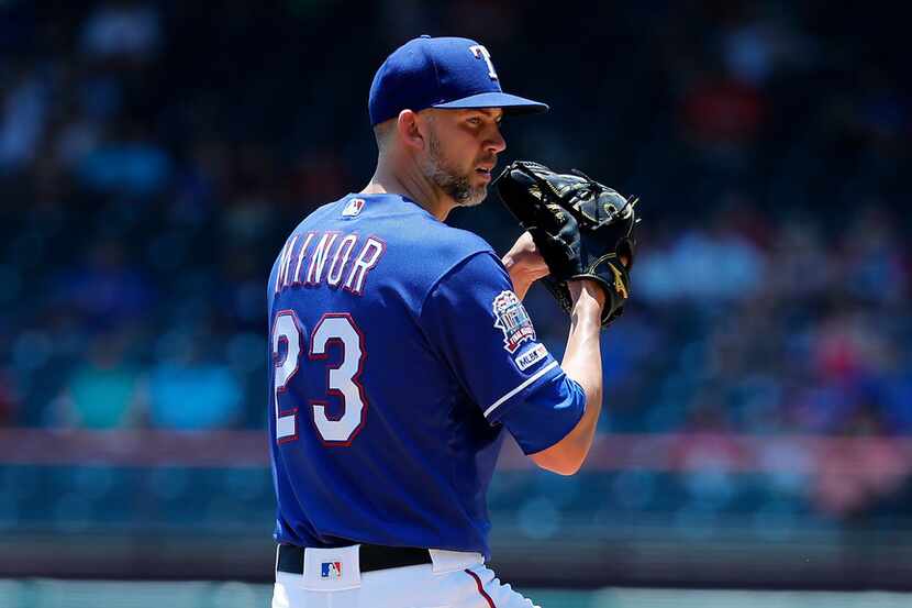 Texas Rangers starting pitcher Mike Minor winds up to deliver to the Cleveland Indians...