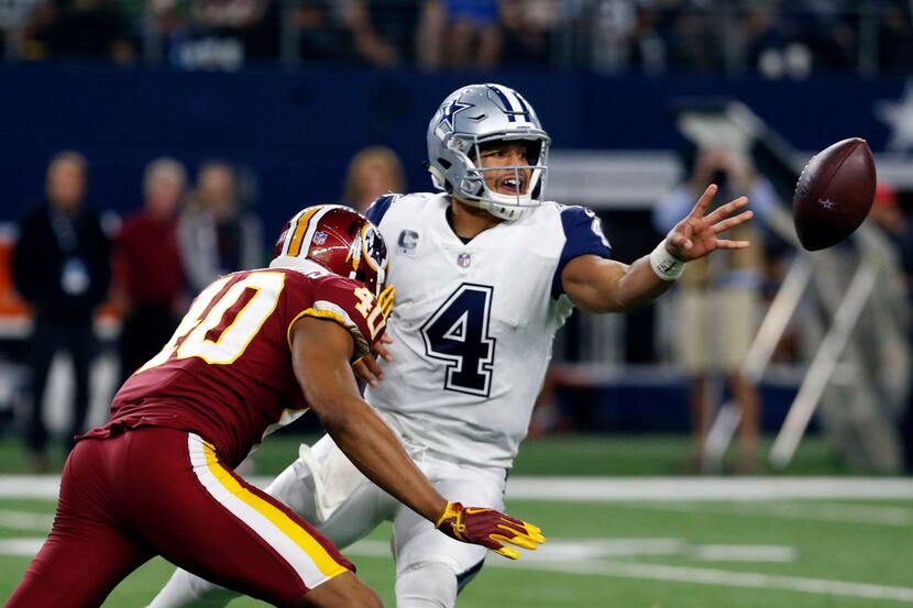 Dallas Cowboys quarterback Dak Prescott (4) laterals off the ball during the first half of a...