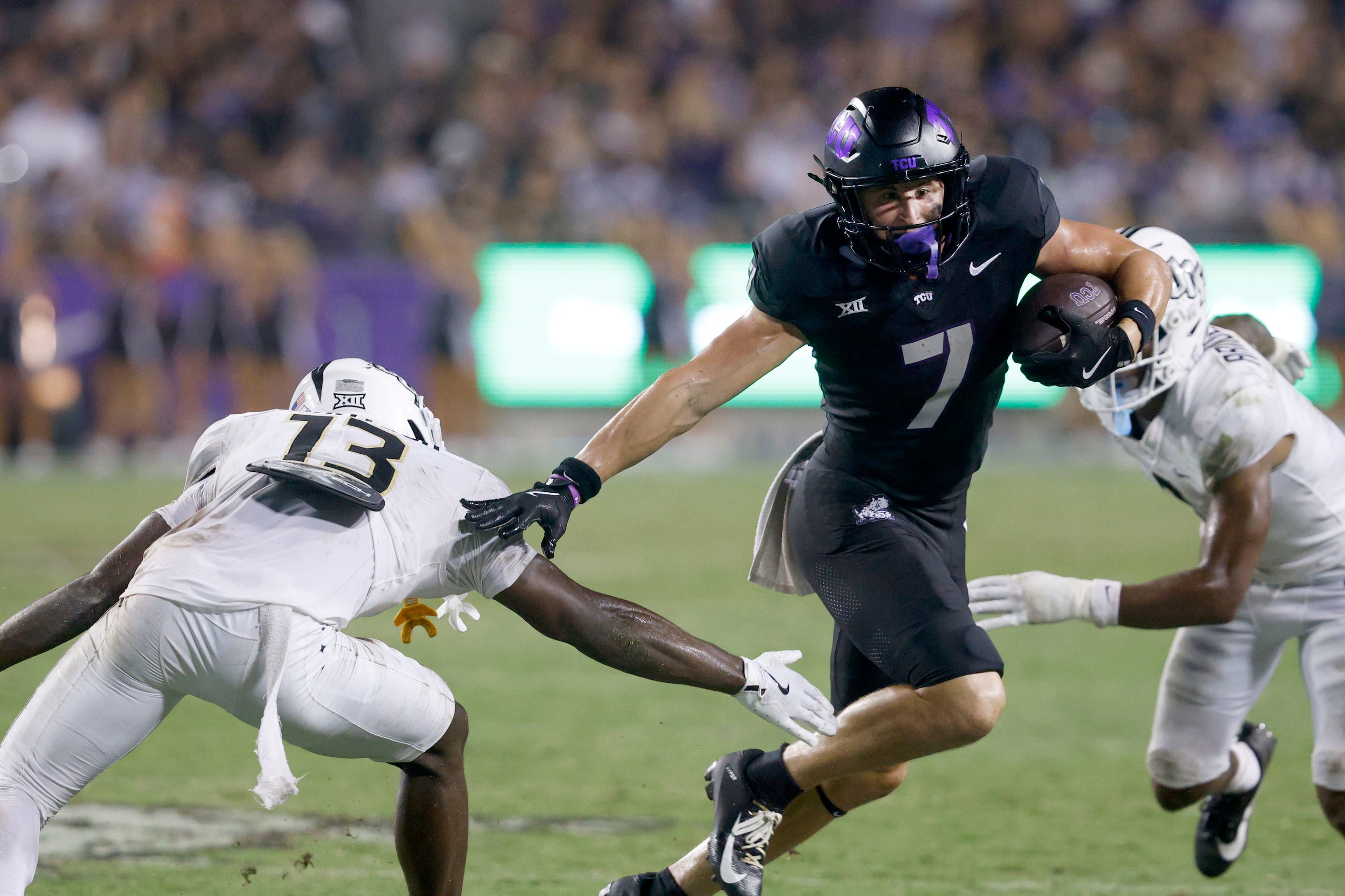 TCU wide receiver JP Richardson (7) keeps the ball away from UCF defensive back Ladarius...