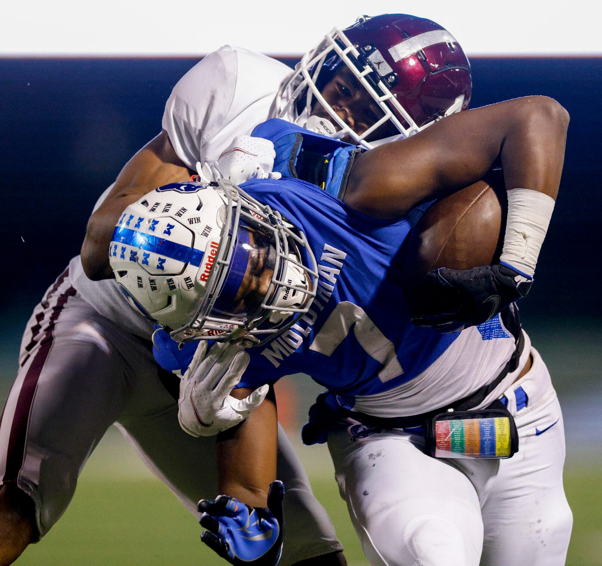 Red Oak defensive back Warren Roberson (1) tackles Midlothian running back De’ago Benson (7)...