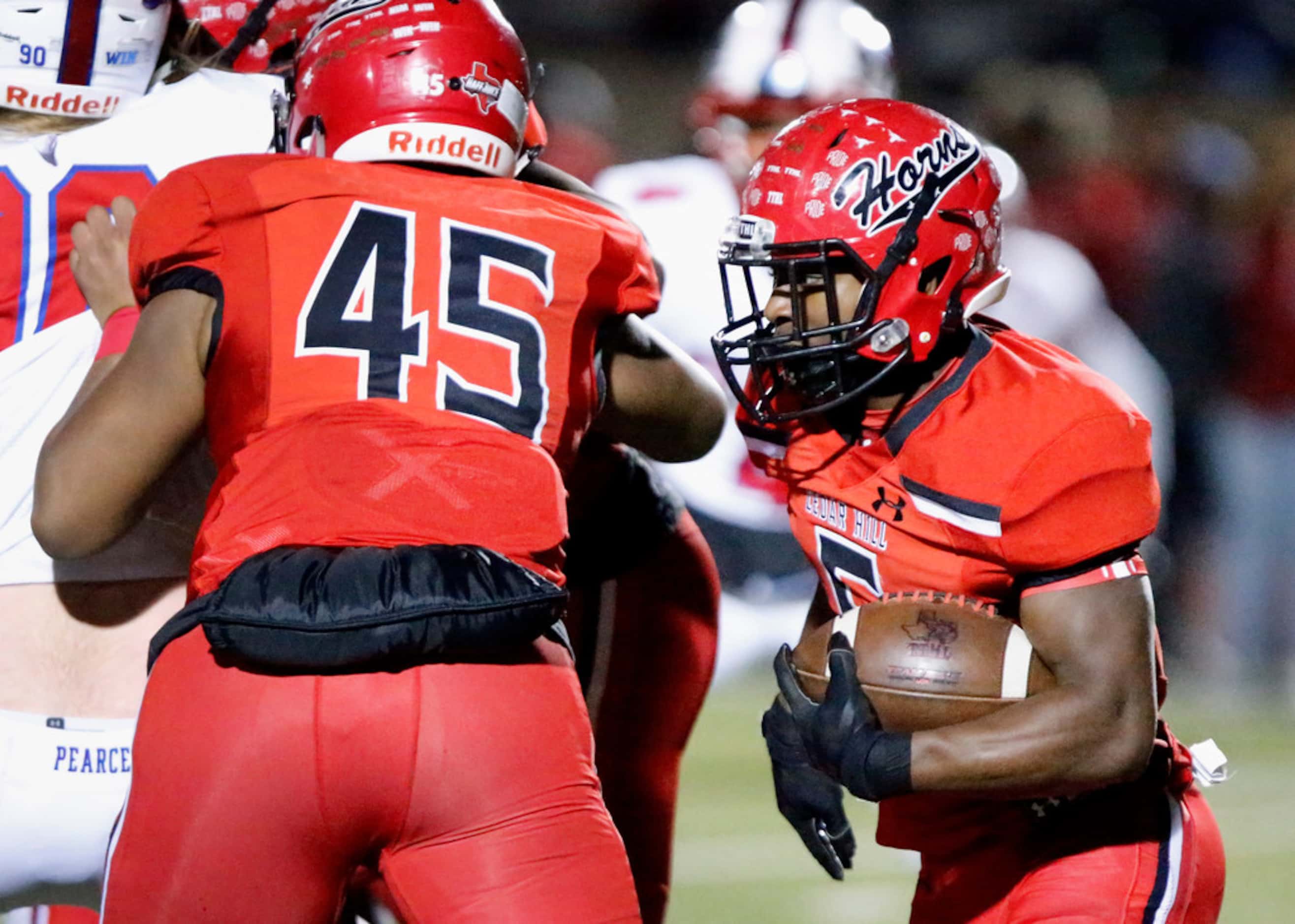 Cedar Hill High School running back Kevin Young, jr. (5) looks for room to run during the...