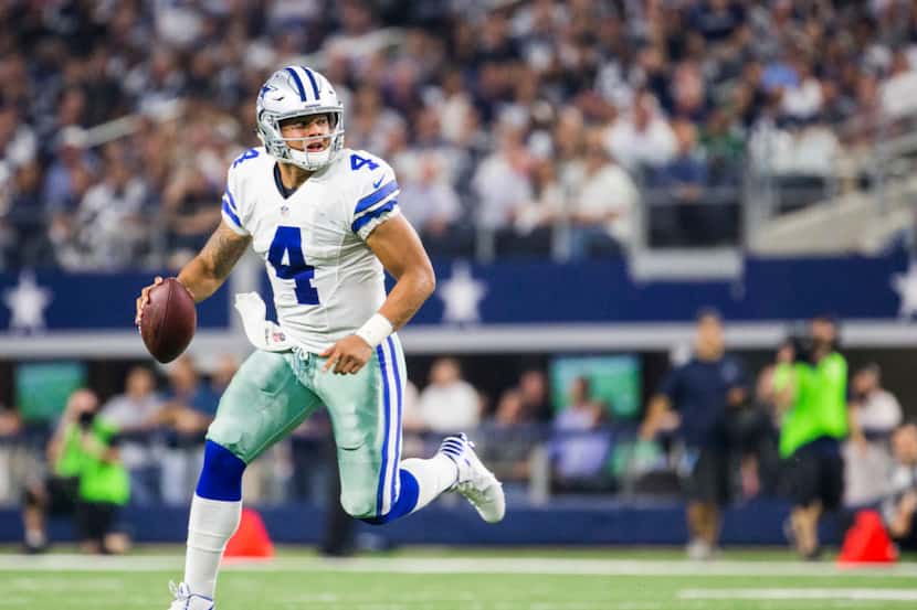 Dallas Cowboys quarterback Dak Prescott (4) runs the ball during the second quarter of their...